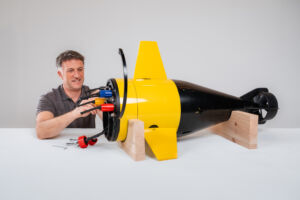 Engineer servicing aft section of UUV